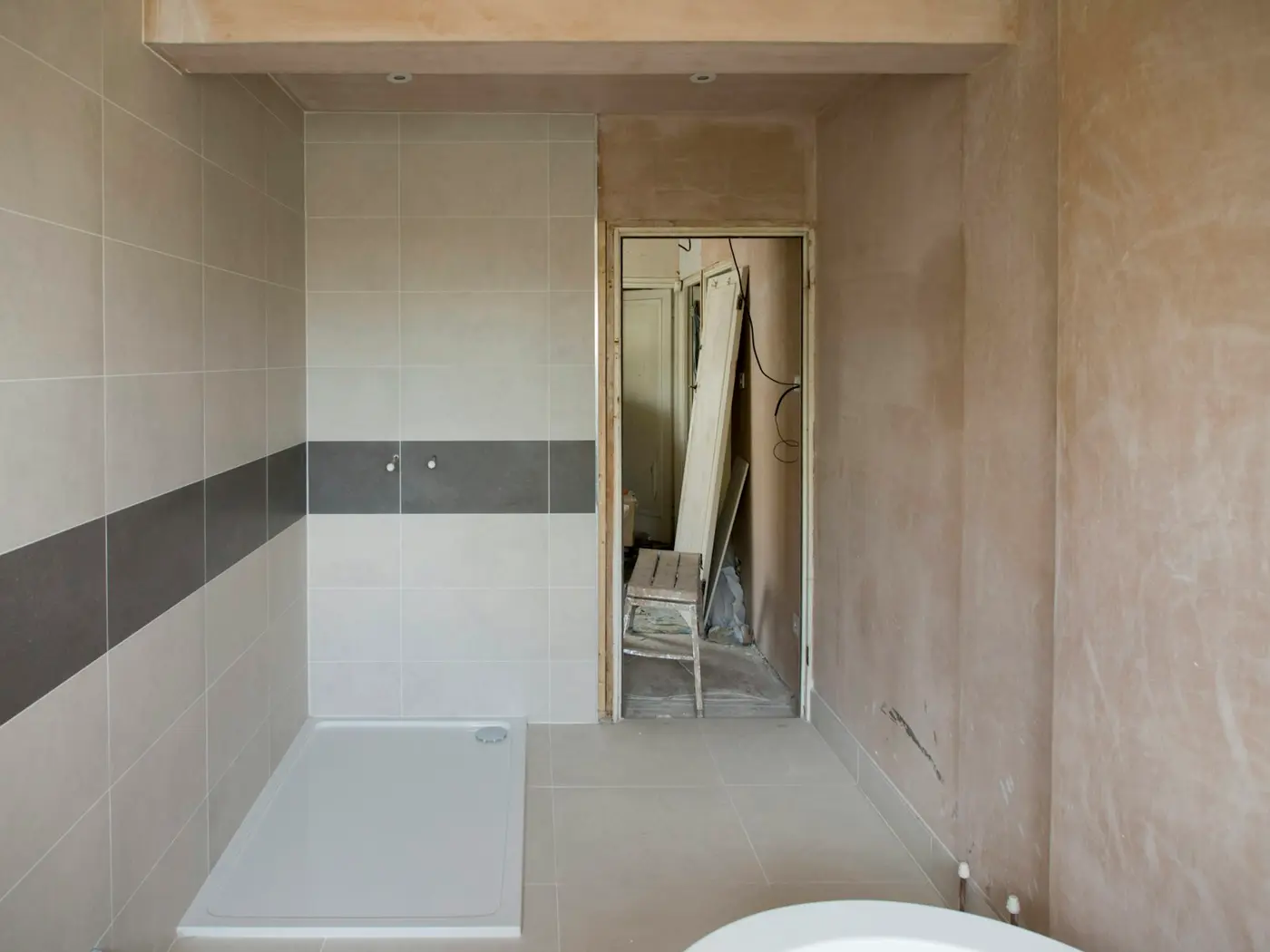 Bathtub and sink partway through a bathroom renovation